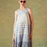 Model wearing blue crinkled empire-line shift dress with layered block-print stripes and pockets – RA Studio