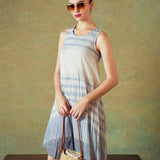 Model wearing blue crinkled empire-line shift dress with layered block-print stripes and pockets – RA Studio