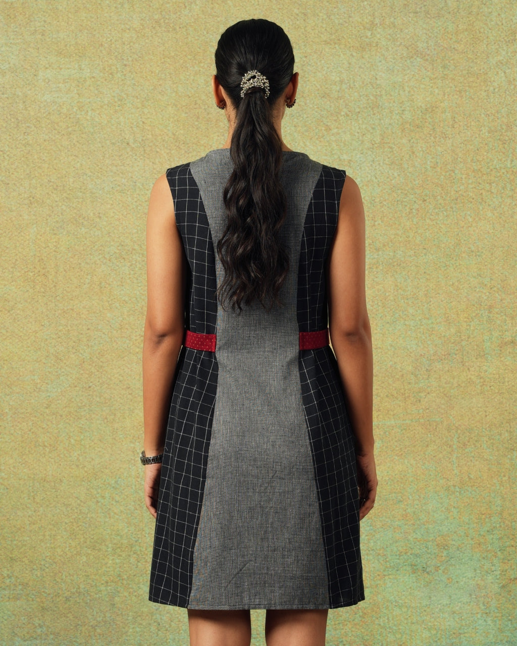 Back view of Sleeveless black and grey panel A-line dress with red belt detailing – RA Studio
