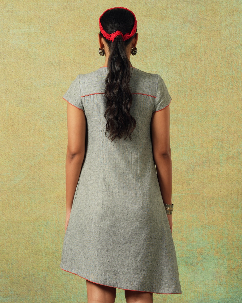 Back view of Short-sleeved grey A-line dress with subtle black and white accents – RA Studio