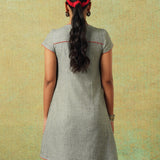 Back view of Short-sleeved grey A-line dress with subtle black and white accents – RA Studio