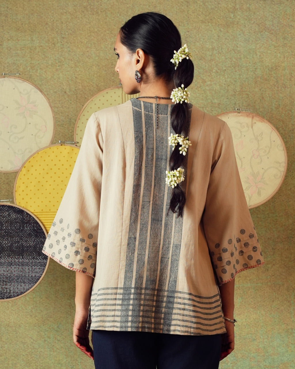 Back view of beige block-printed tunic with princess line cut