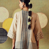 Back view of beige block-printed tunic with princess line cut