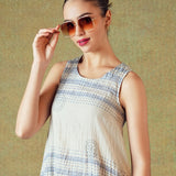 Close up of Model wearing blue crinkled empire-line shift dress with layered block-print stripes and pockets – RA Studio