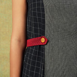 Close up of Sleeveless black and grey panel A-line dress with red belt detailing – RA Studio