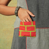 Close-up of orange patch pocket on grey patchwork dress – RA Studio