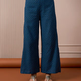 Blue flared pants with gold dot block-print detailing