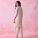 Beige cotton Mangalgiri co-ord with a front-pleated button kurta and contrast top stitching on the kurta and pant hems.