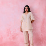 Beige cotton Mangalgiri co-ord with a front-open mid-length kurta and straight pants, both with slot detailing.