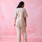 Beige cotton Mangalgiri co-ord with a front-open mid-length kurta and straight pants, both with slot detailing.