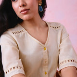 Beige cotton Mangalgiri co-ord with a front-open mid-length kurta and straight pants, both with slot detailing.