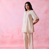 Beige cotton Mangalgiri co-ord with a front-open mid-length kurta and straight pants, both with slot detailing.