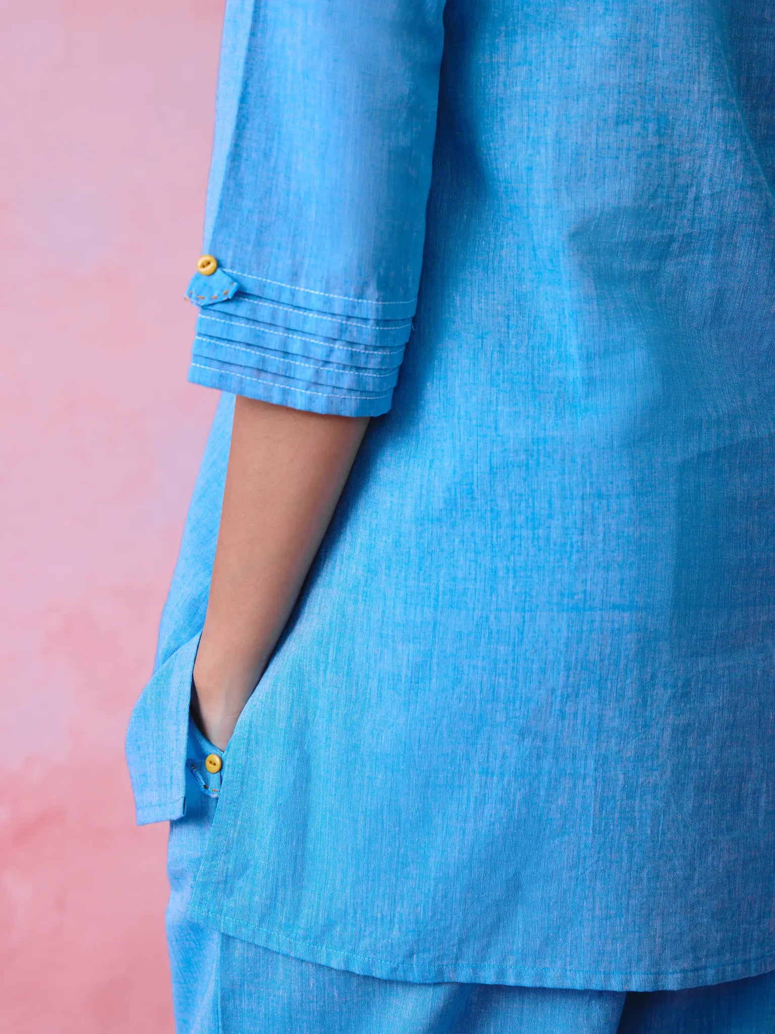 Blue cotton Mangalgiri kurta and pant co-ord with multicolour buttons, hand embroidery and cotton-bell details.