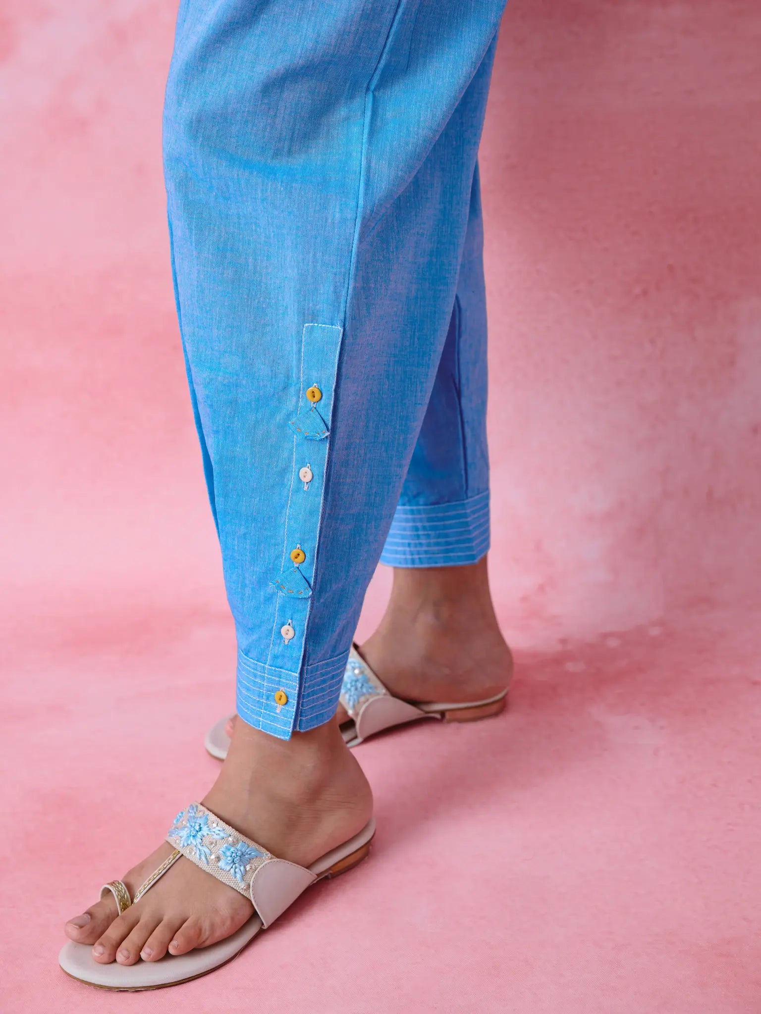 Blue cotton Mangalgiri kurta and pant co-ord with multicolour buttons, hand embroidery and cotton-bell details.
