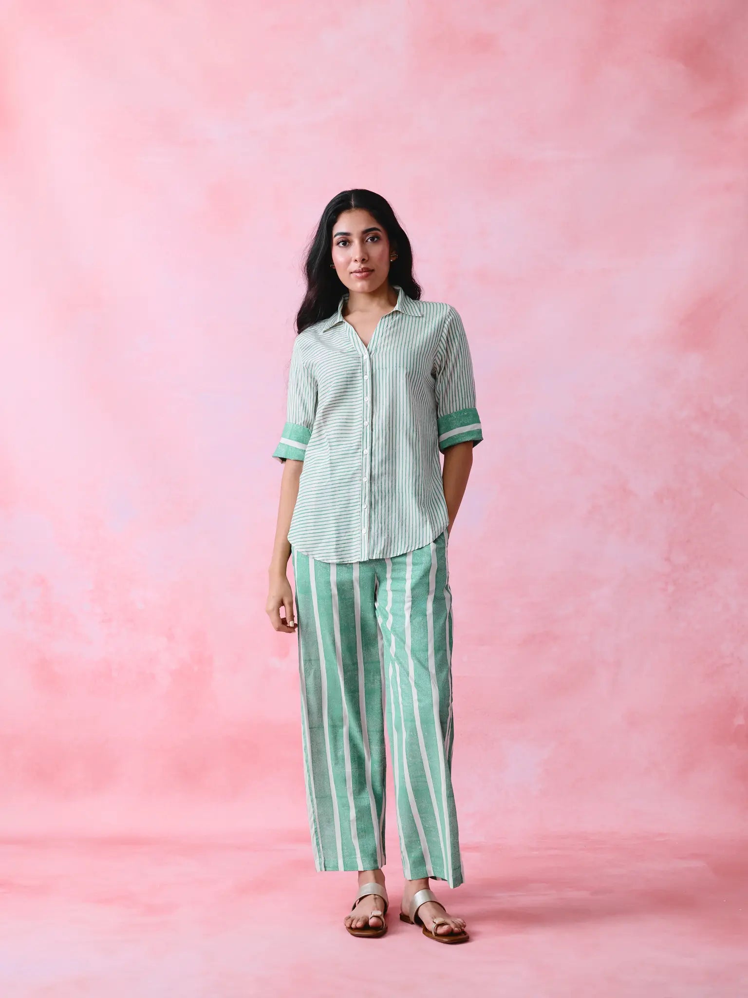 Green cotton co-ord with a thin-stripe block-print collared tunic shirt, turn-up sleeves and wide-stripe flared pants.