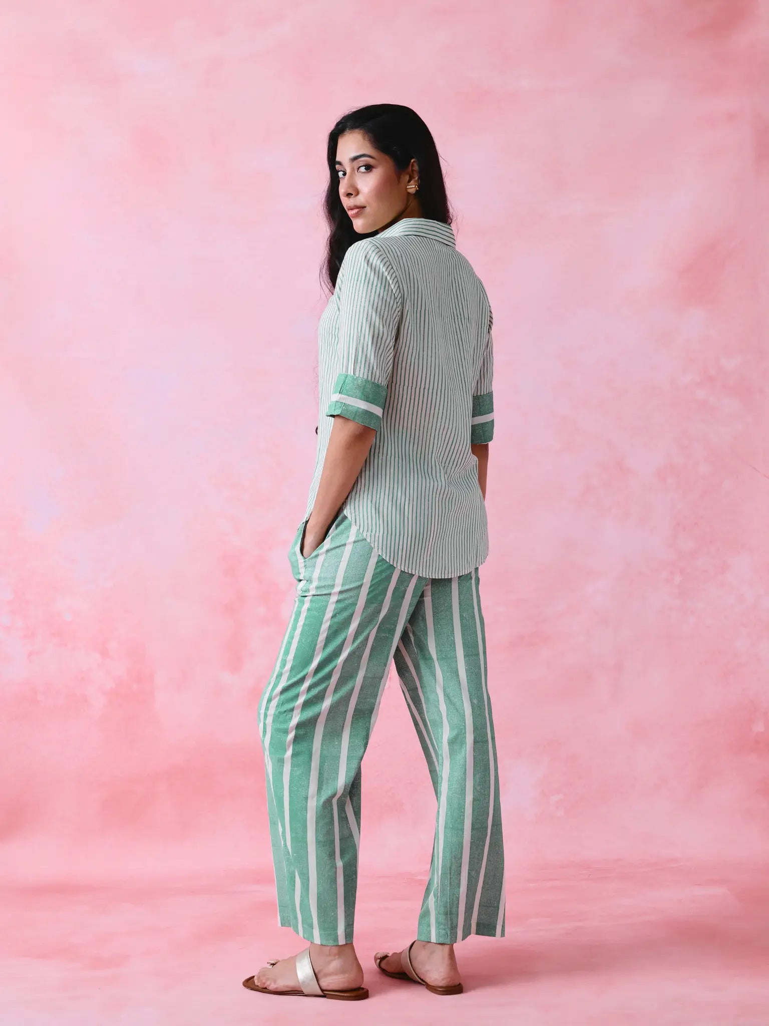 Green cotton co-ord with a thin-stripe block-print collared tunic shirt, turn-up sleeves and wide-stripe flared pants.