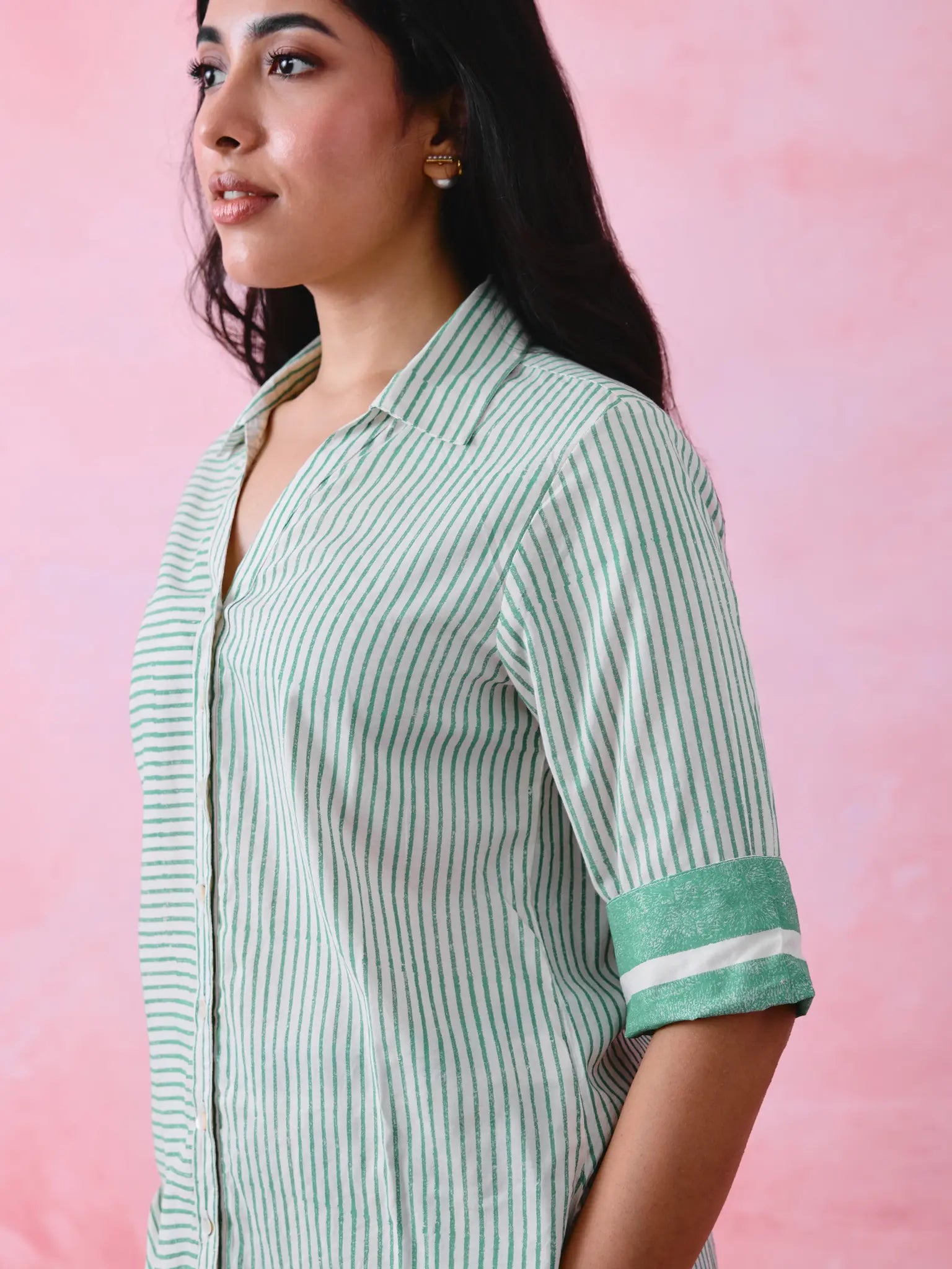 Green cotton co-ord with a thin-stripe block-print collared tunic shirt, turn-up sleeves and wide-stripe flared pants.