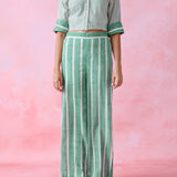 Green cotton co-ord with a thin-stripe block-print collared tunic shirt, turn-up sleeves and wide-stripe flared pants.