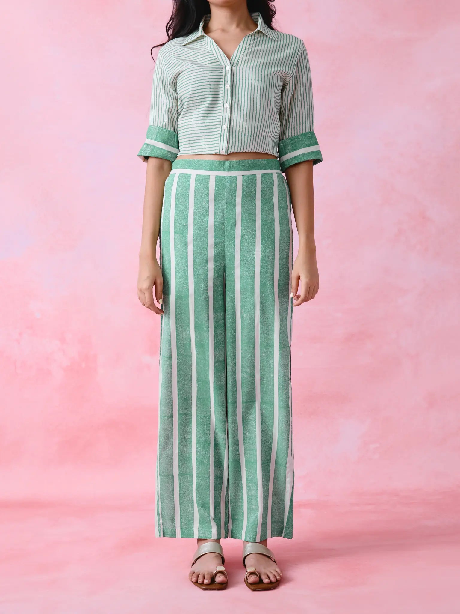 Green cotton co-ord with a thin-stripe block-print collared tunic shirt, turn-up sleeves and wide-stripe flared pants.