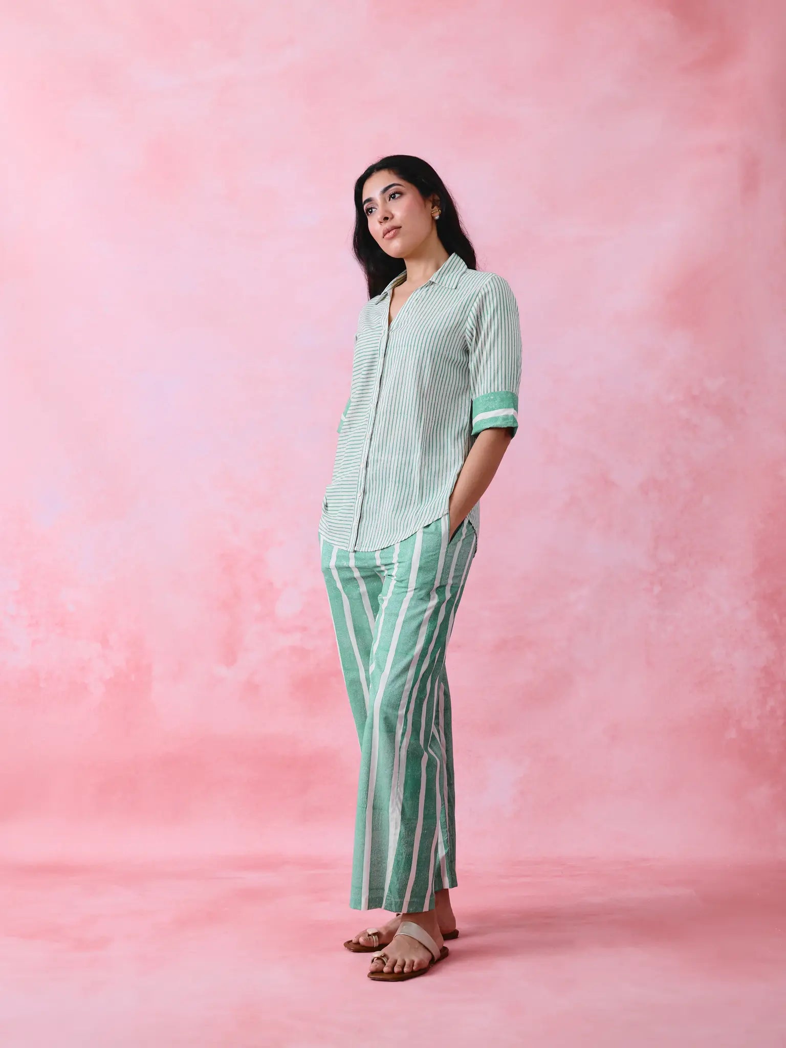 Green cotton co-ord with a thin-stripe block-print collared tunic shirt, turn-up sleeves and wide-stripe flared pants.