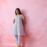 Grey cotton Mangalgiri kurta and straight-pant co-ord with a flap collar, loop buttons and mustard-yellow accents.