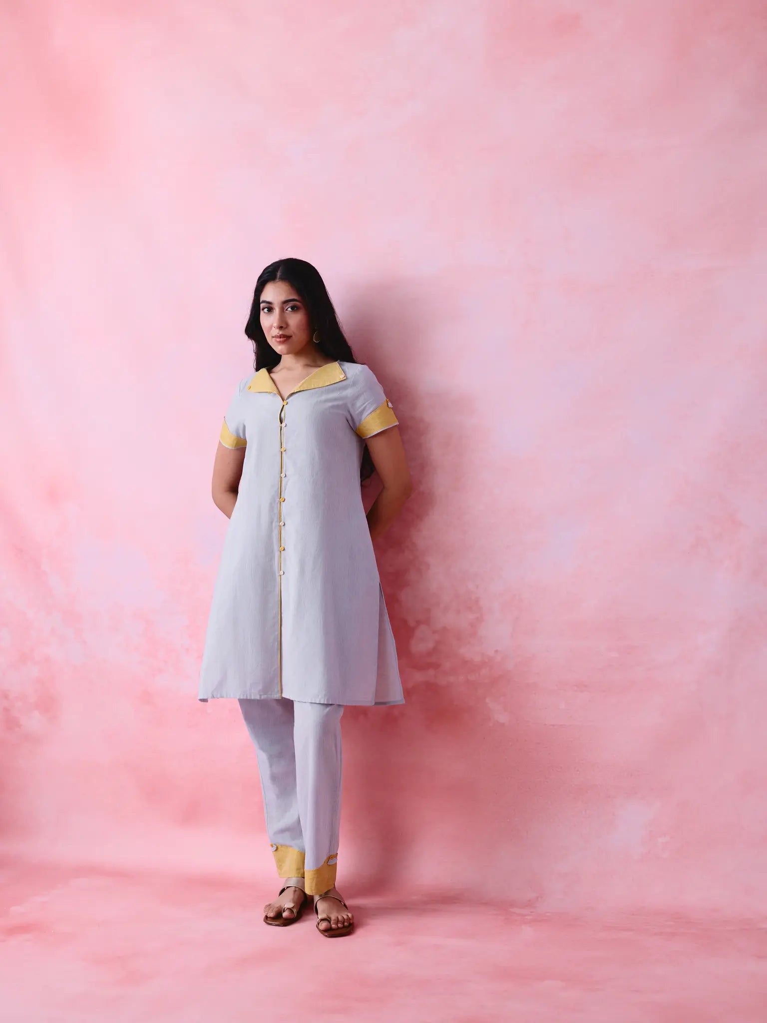 Grey cotton Mangalgiri kurta and straight-pant co-ord with a flap collar, loop buttons and mustard-yellow accents.