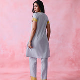 Grey cotton Mangalgiri kurta and straight-pant co-ord with a flap collar, loop buttons and mustard-yellow accents.