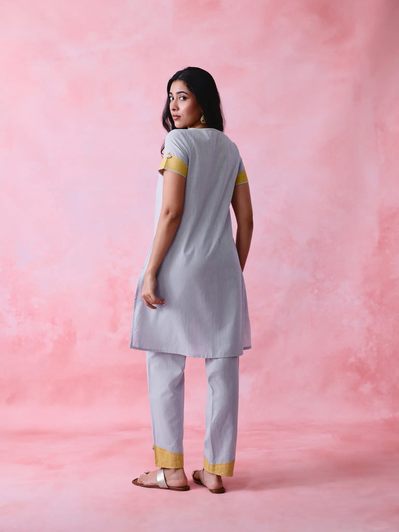 Grey cotton Mangalgiri kurta and straight-pant co-ord with a flap collar, loop buttons and mustard-yellow accents.