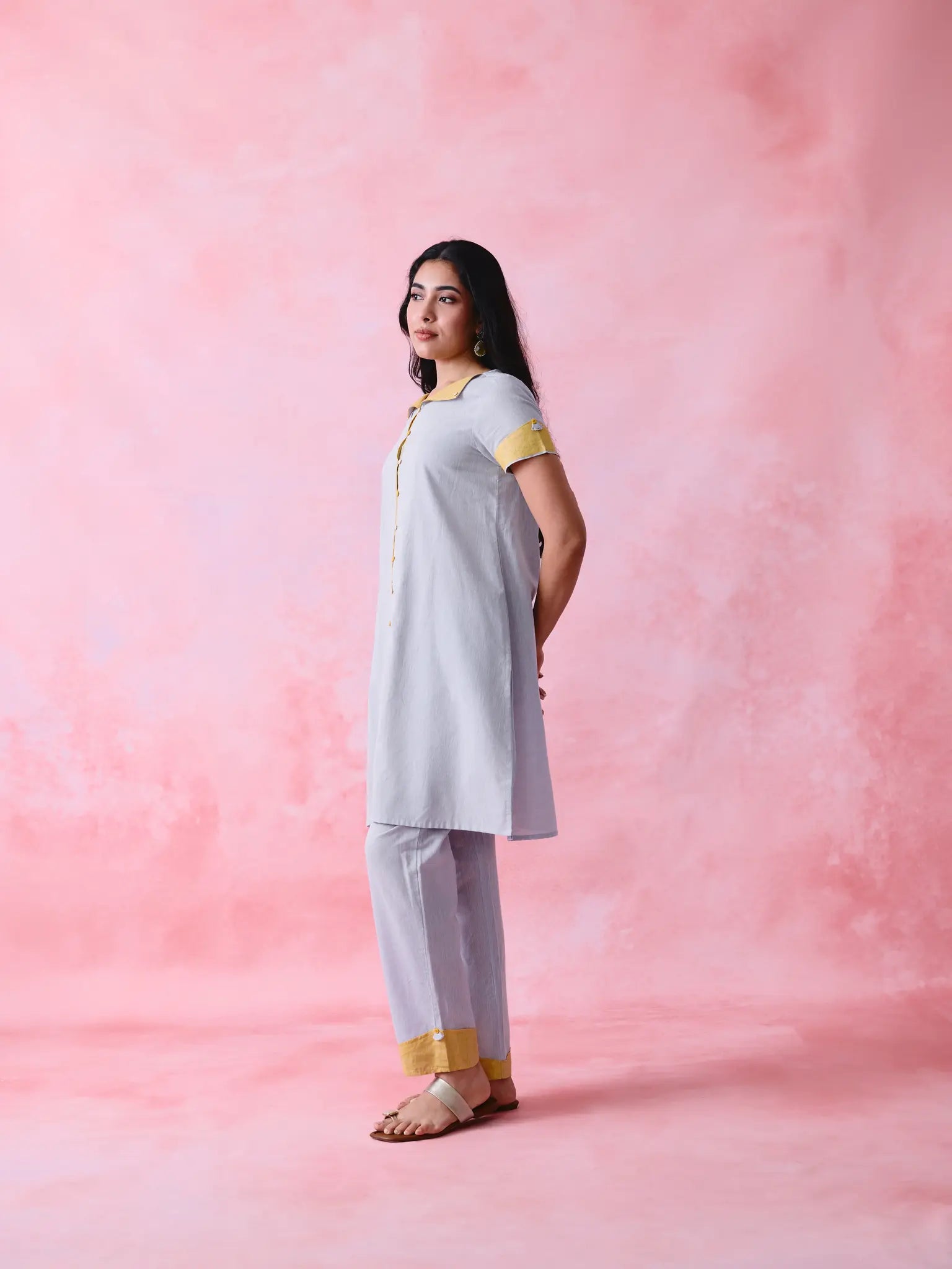 Grey cotton Mangalgiri kurta and straight-pant co-ord with a flap collar, loop buttons and mustard-yellow accents.