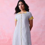 Grey cotton Mangalgiri kurta and straight-pant co-ord with a flap collar, loop buttons and mustard-yellow accents.
