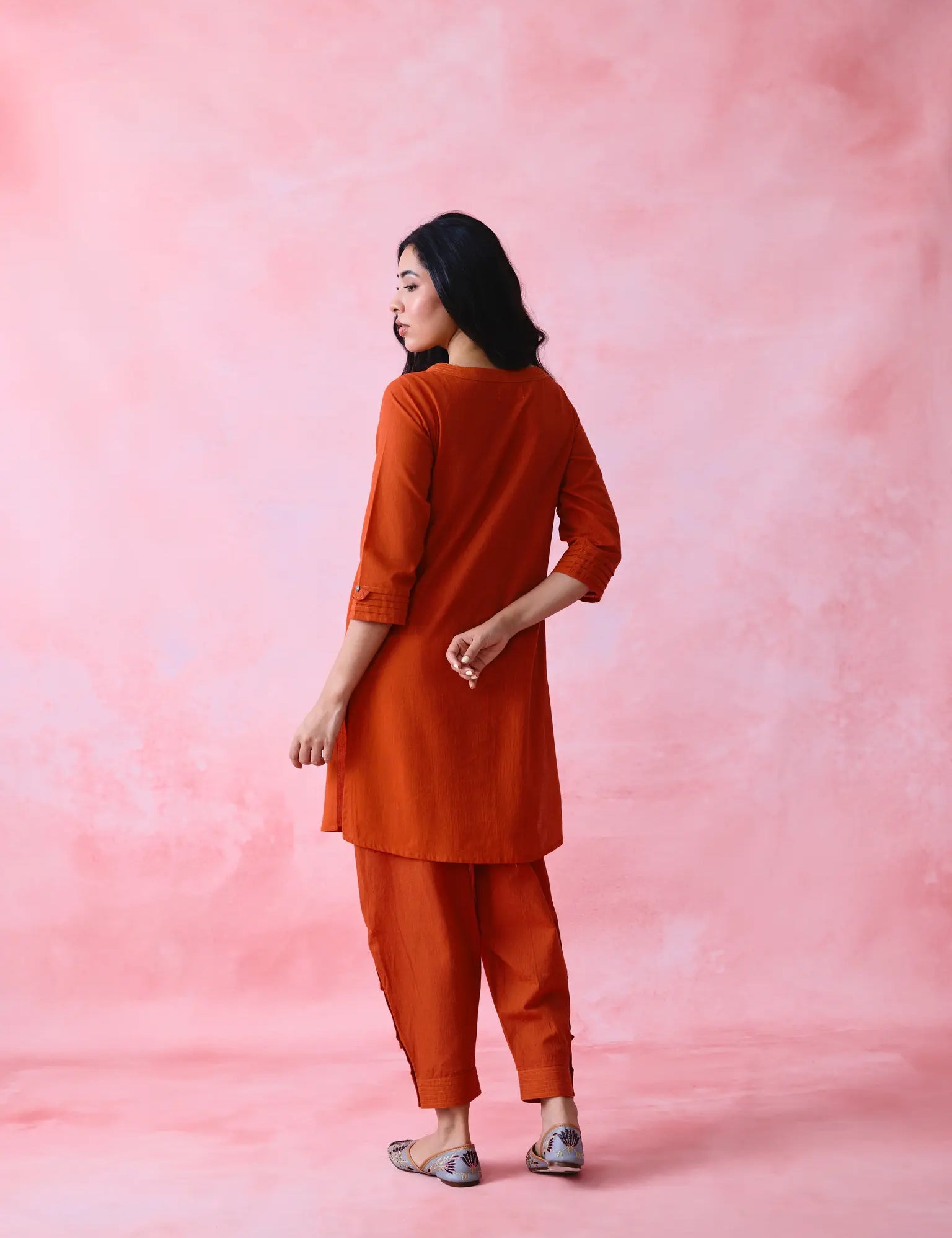 Woman wearing red pleated kurta set