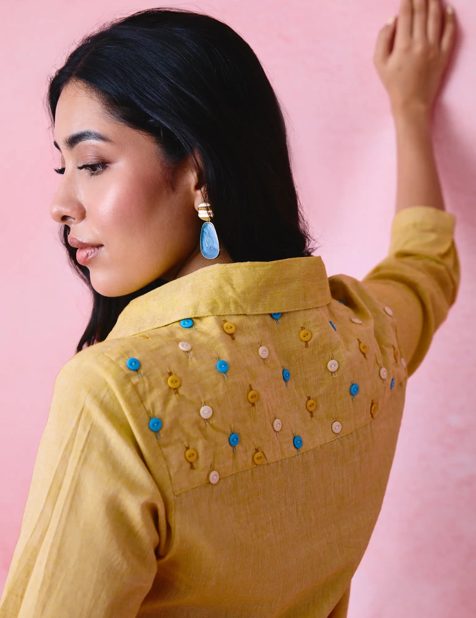 Yellow shirt with multicolour buttons