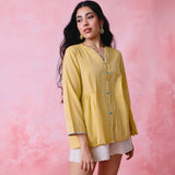 Yellow cotton Mangalgiri tunic with side gathers, front loop buttons and contrasting grey trim.