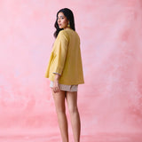 Yellow cotton Mangalgiri tunic with side gathers, front loop buttons and contrasting grey trim.