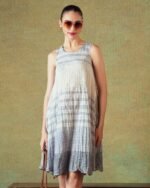 Model wearing blue crinkled empire-line shift dress with layered block-print stripes and pockets – RA Studio