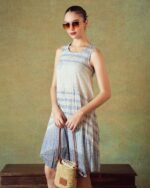 Model wearing blue crinkled empire-line shift dress with layered block-print stripes and pockets – RA Studio