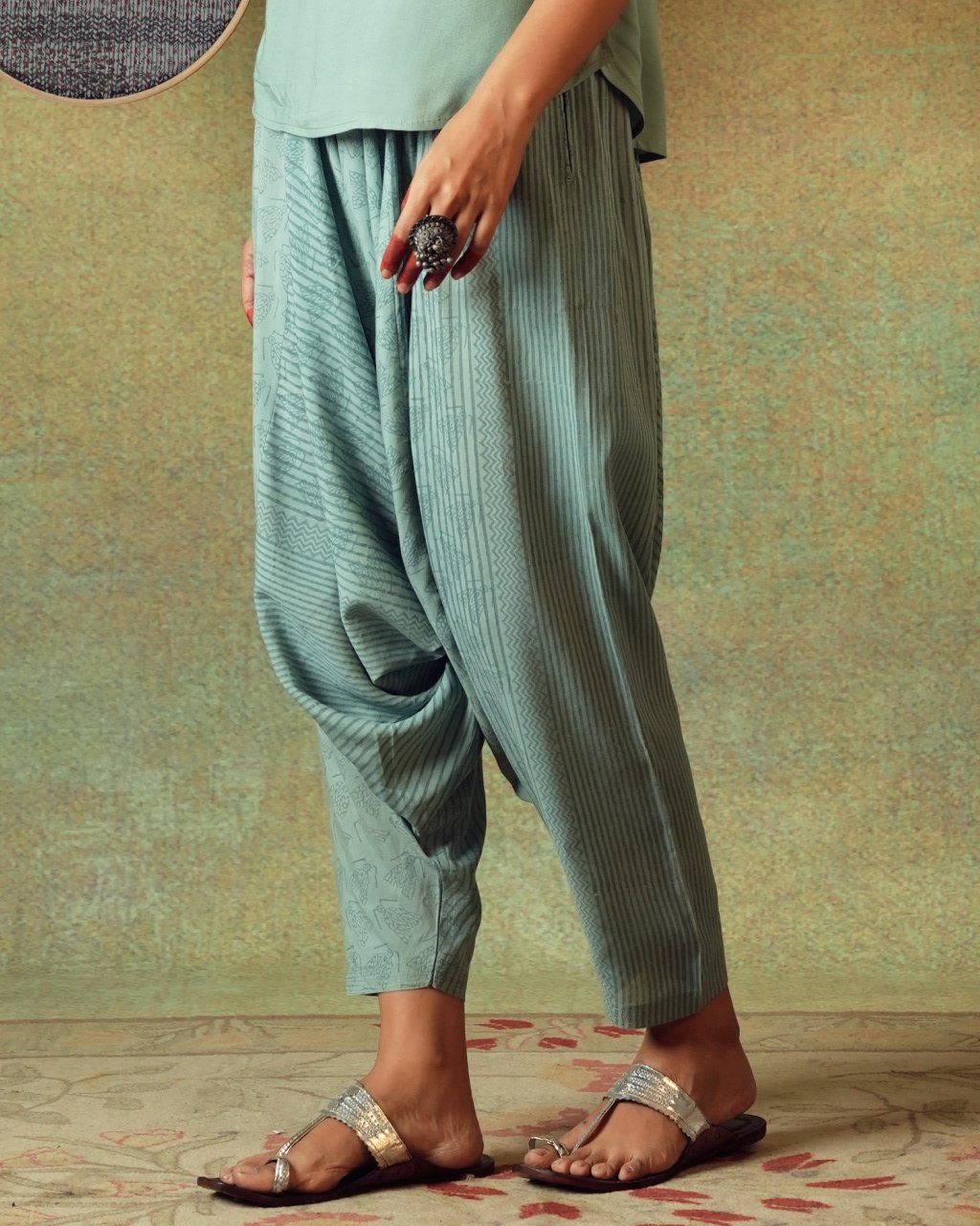 Close-up of moth block print detail on green Turkish pants – RA Studio