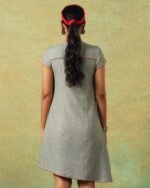 Back view of Short-sleeved grey A-line dress with subtle black and white accents – RA Studio