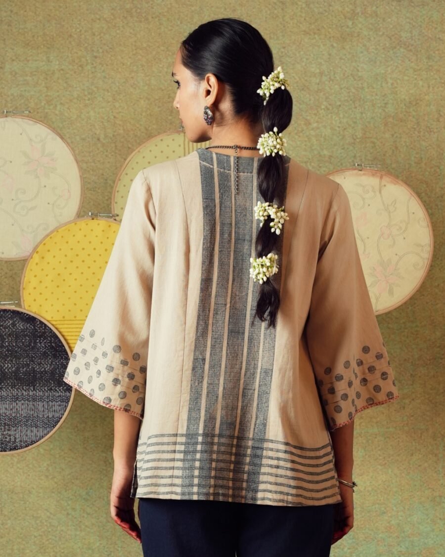 Back view of beige block-printed tunic with princess line cut