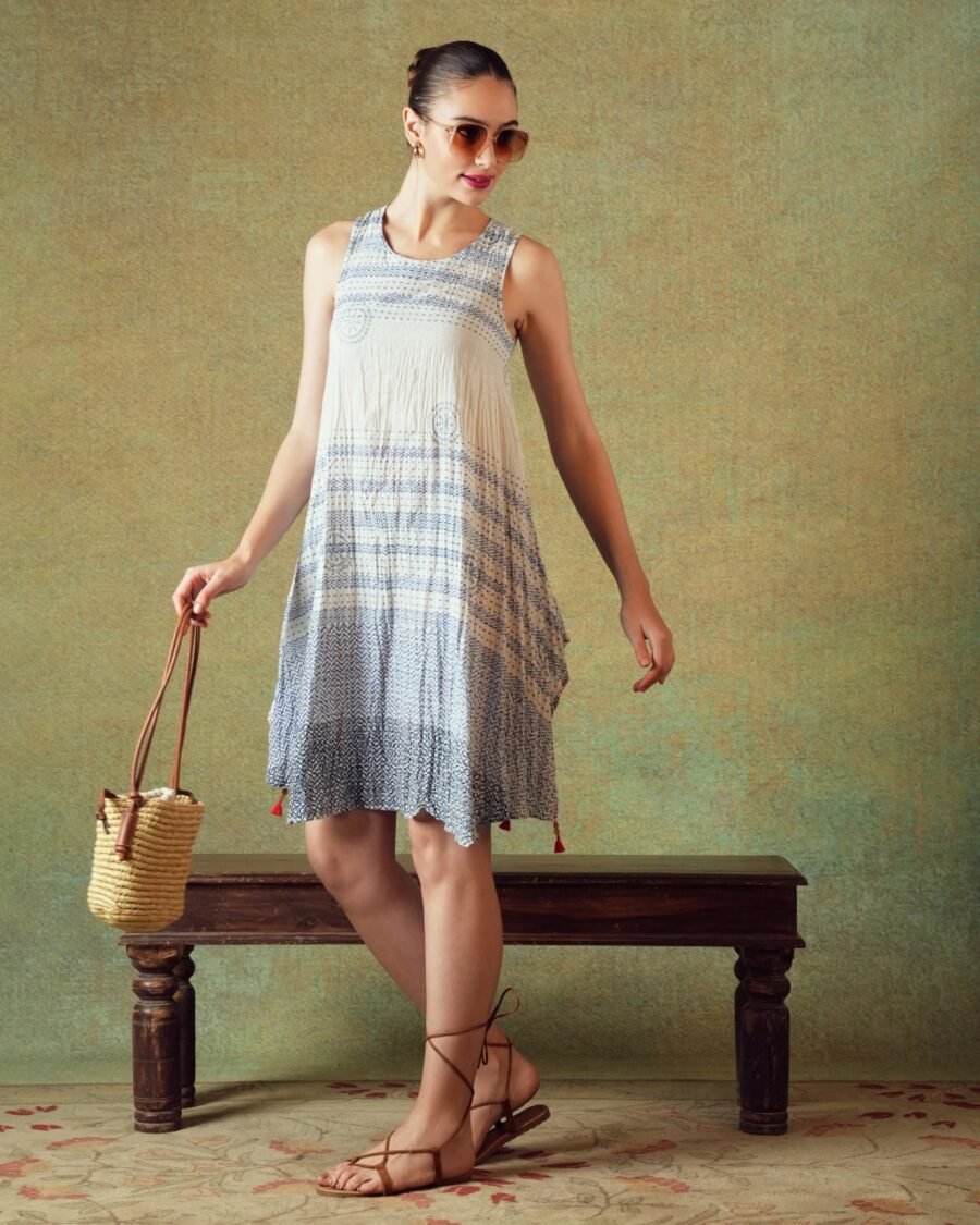 Model wearing blue crinkled empire-line shift dress with layered block-print stripes and pockets – RA Studio