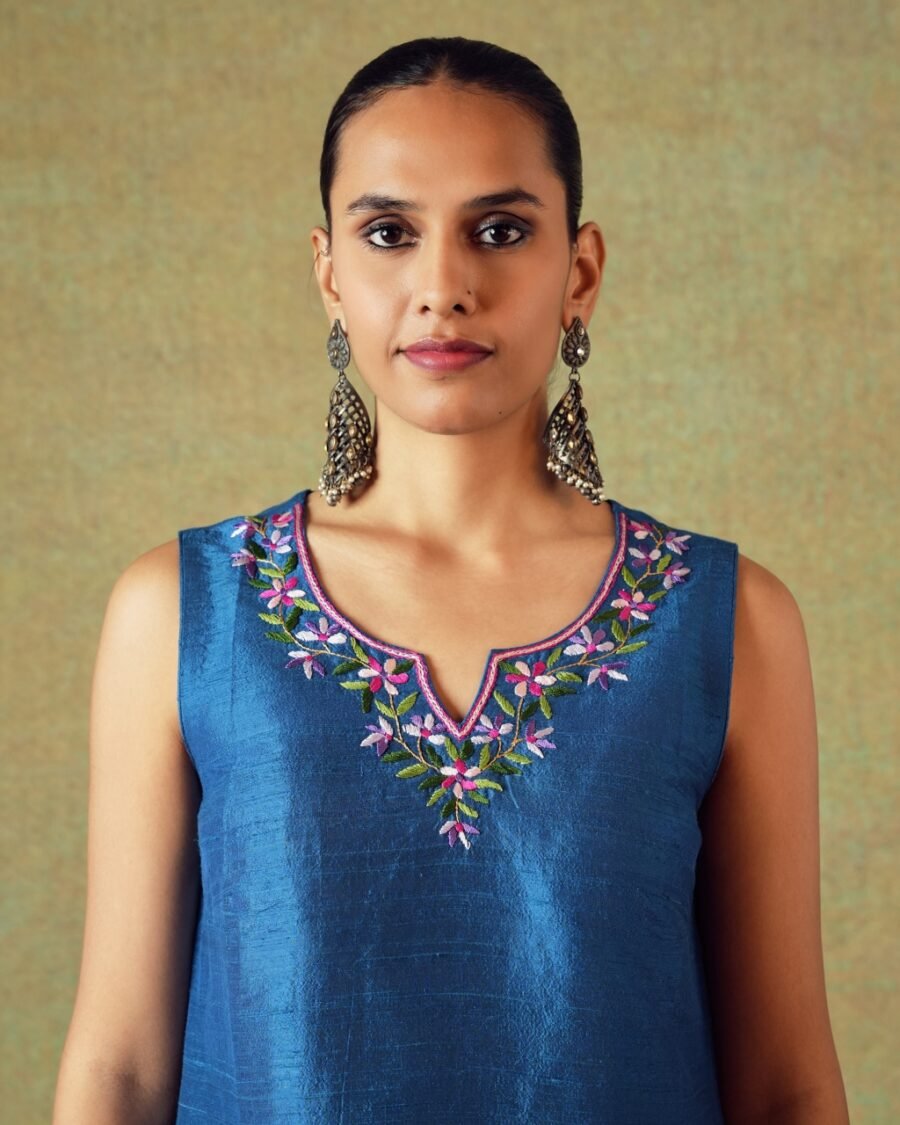 Close-up of blue Dupion silk hand embroidery on sleeveless top