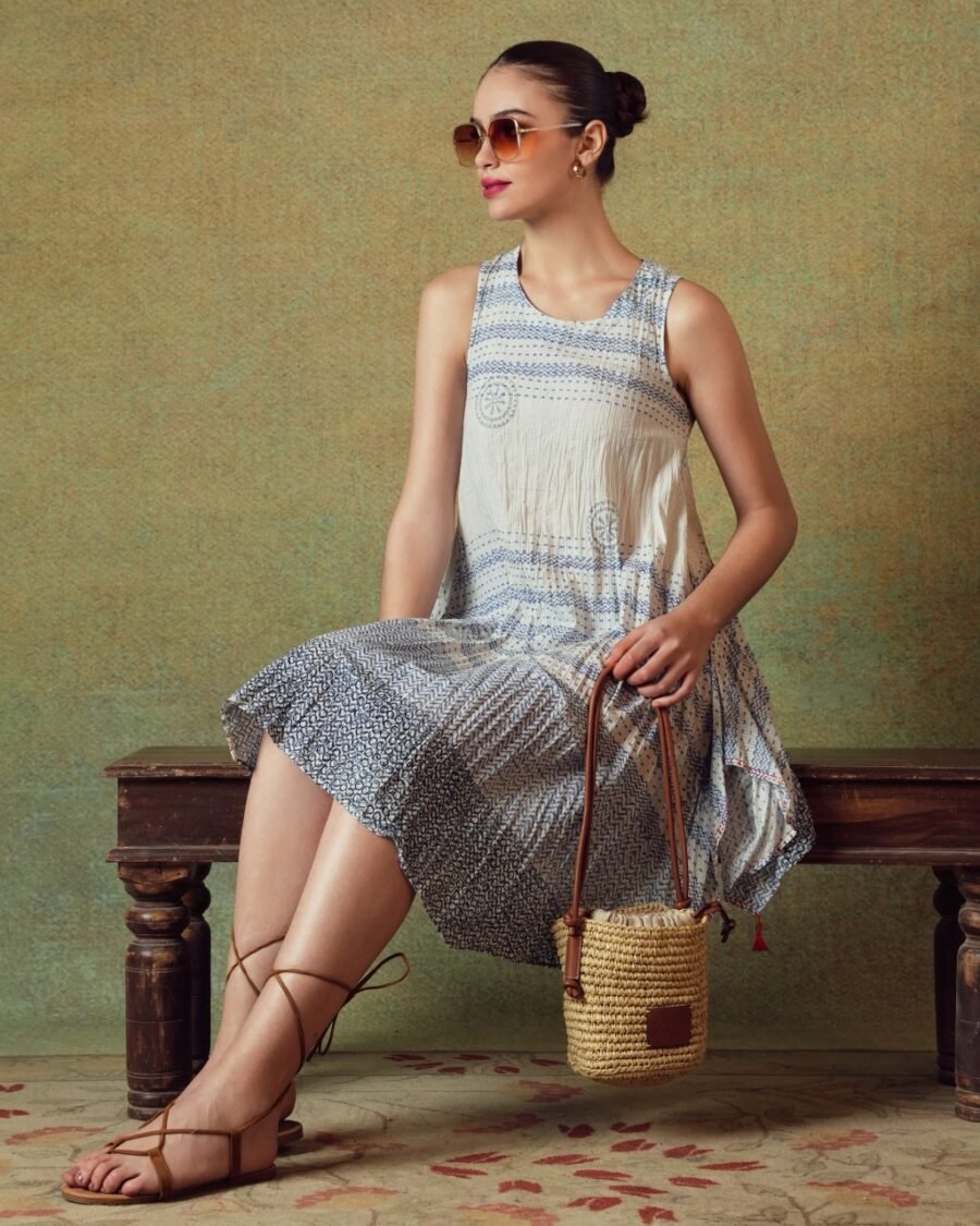 Model wearing blue crinkled empire-line shift dress with layered block-print stripes and pockets – RA Studio