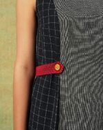 Close up of Sleeveless black and grey panel A-line dress with red belt detailing – RA Studio