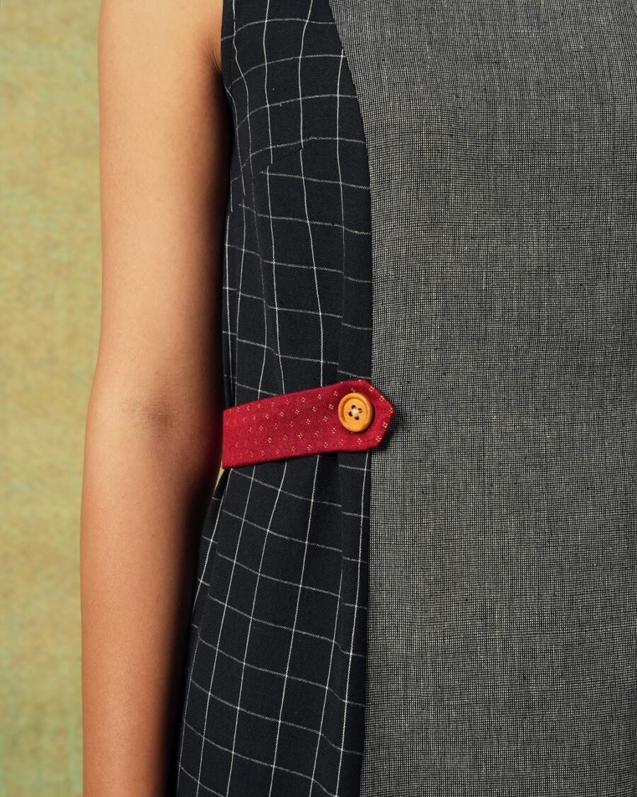 Close up of Sleeveless black and grey panel A-line dress with red belt detailing – RA Studio
