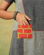 Close-up of orange patch pocket on grey patchwork dress – RA Studio