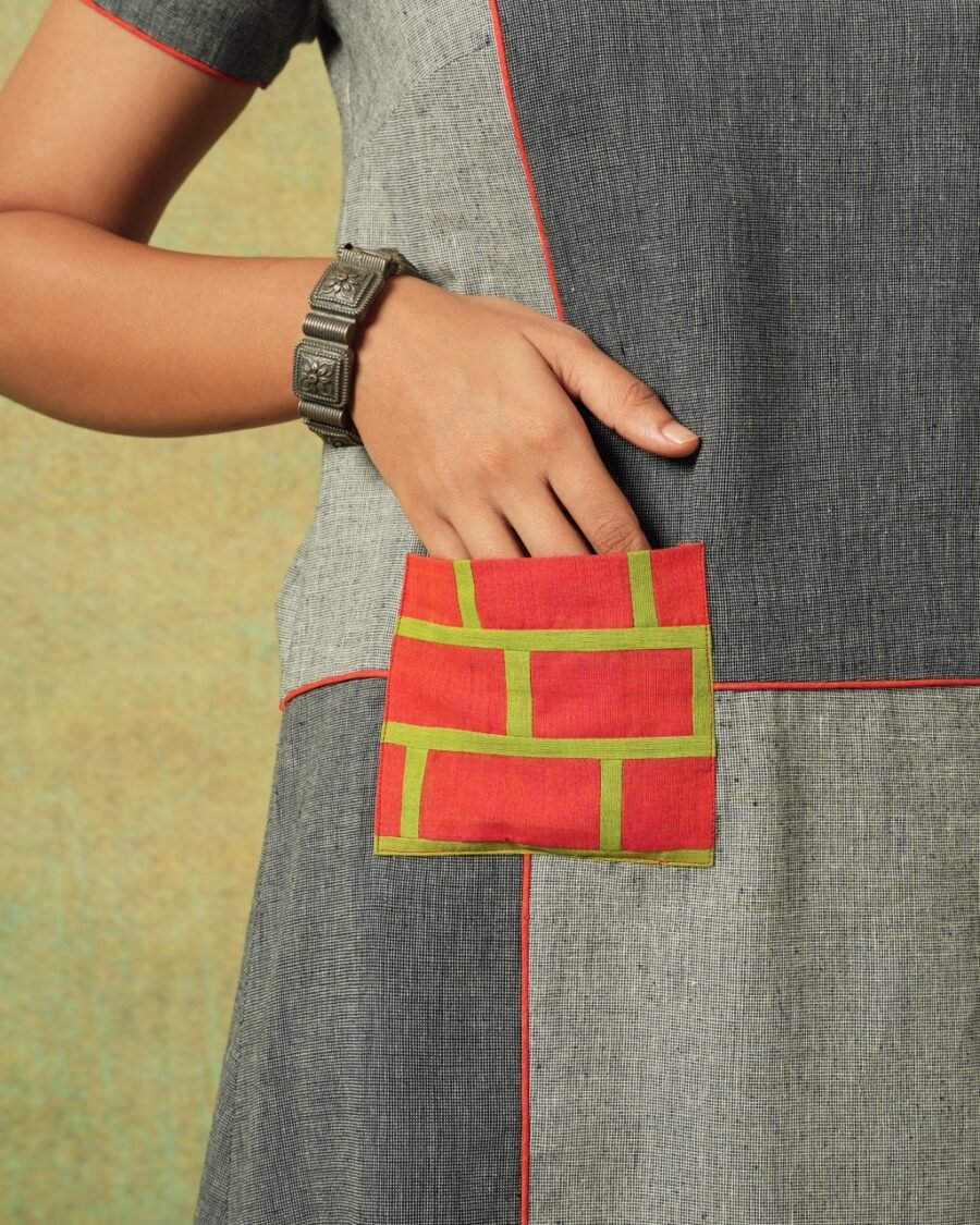 Close-up of orange patch pocket on grey patchwork dress – RA Studio